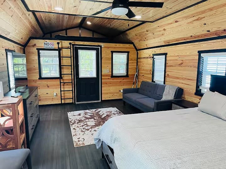 Bunk room with cowhide rug inside a Moto Supreme cabin