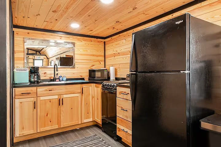 Cabin kitchen with full-size refrigerator and range at Moto Supreme