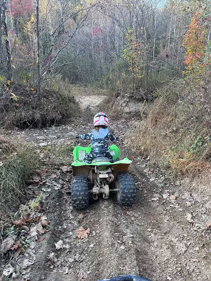 Private off-road trail winding through the woods at Moto Supreme